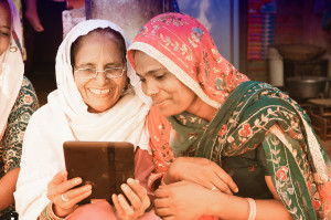 Women from India use their tablet to connect with family over social networks.