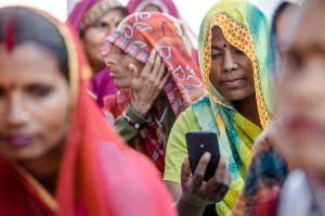 An Indian woman uses her smartphone to track and manage information.