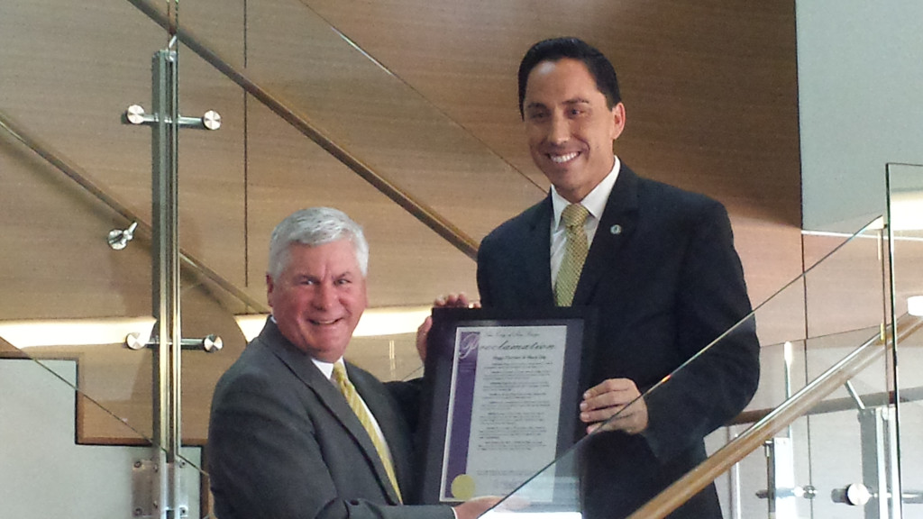 John Morell accepts proclamation from Councilman Todd Gloria honoring the 75th anniversary of Higgs Fletcher & Mack.