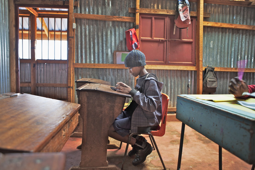 In his classroom, Albert Omwenga Machuk, an 8th grade student in Nairobi, Kenyaworks on a 3G-enabled tablet that has helped him improve his mathematic ranking from No.4 in his class to No. 1.