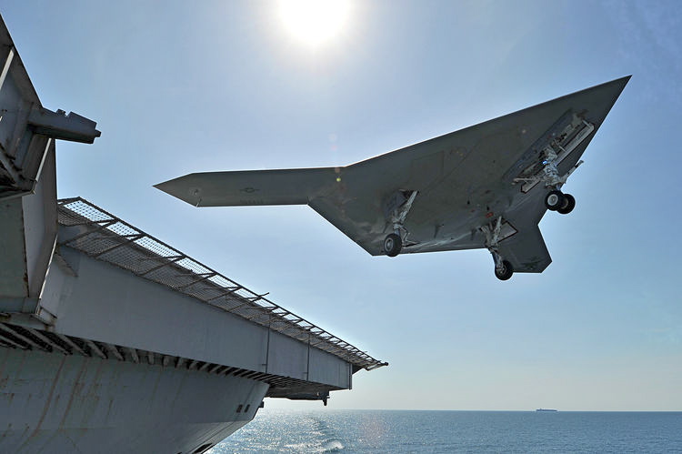 An X-47B unmanned combat air system (UCAS) demonstrator performs a touch and go landing on the flight deck of the aircraft carrier USS George H.W. Bush
