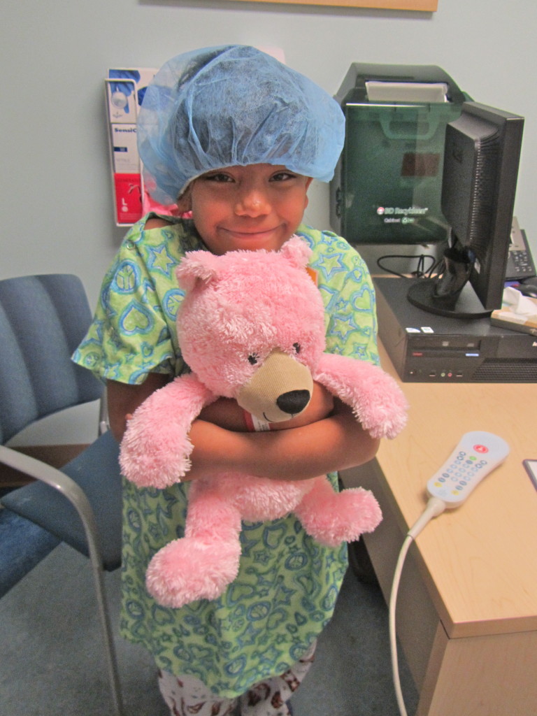 A young patient can’t be without her teddy bear.