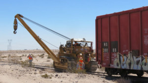 A crew removes an abandoned boxcar from the Desert Line in August. Courtesy Pacific Imperial Railroad