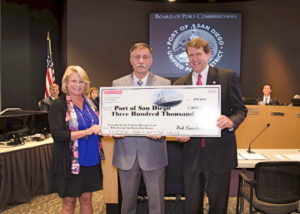 Bob Koerber of BAE Systems San Diego Ship Repair (center) presents a $300,000 check to Port of San Diego CEO Randa Coniglio and Port Chairman Marshall Merrifield. 