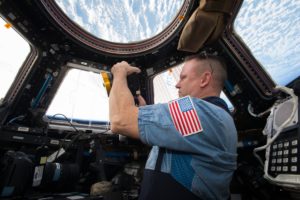 NASA Commander Barry (Butch) Wilmore shoots a scene with the IMAX camera through the window of the International Space Station’s Cupola Observation Module.