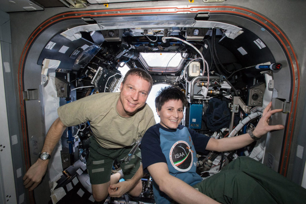 NASA Commander Terry Virts and European Space Agency astronaut Samantha Cristoforetti smiling after her haircut, by Terry.