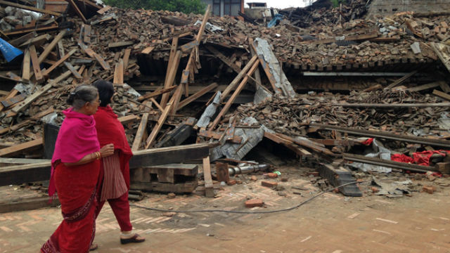 Women view devastation from the earthquake in Nepal. (Photo courtesy USAID)