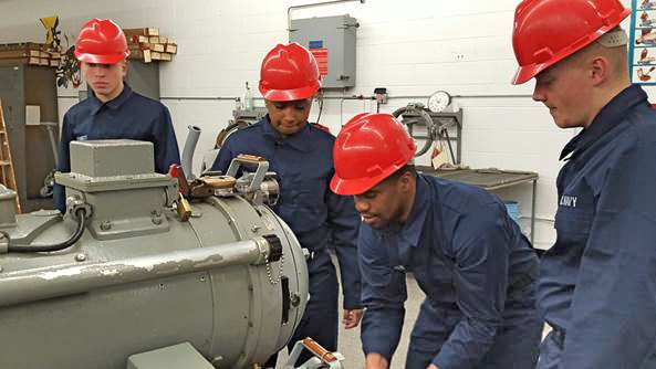 Under the direction of San Diego City College teachers, sailors at Naval Station Great Lakes practice loading inert torpedoes in the Surface Vessel Torpedo Tubes Lab. (Photo courtesy of SDCCD)