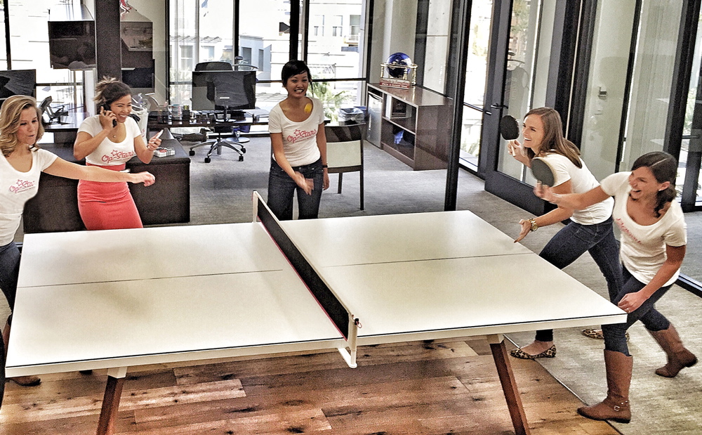 Hughes Marino employees enjoying a table tennis game.