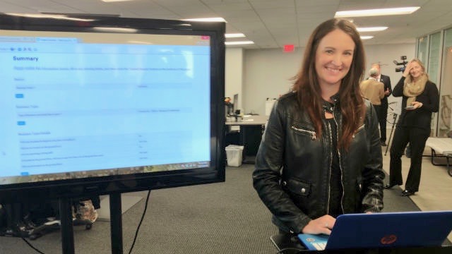 Melanie Gordon of TapHunter demonstrates the city’s OpenCounty service. (Photo by Chris Jennewein/Times of San Diego)