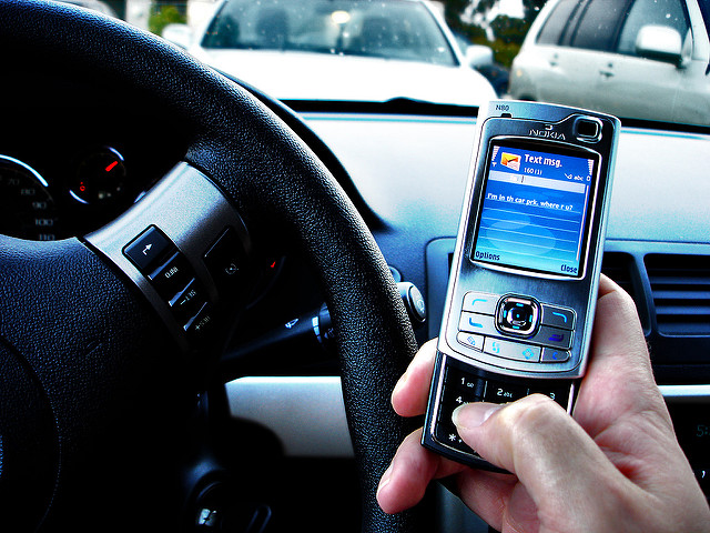 Texting while driving. (Photo by Tim Caynes via Flickr)