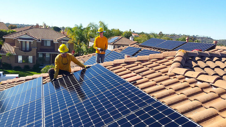Sullivan Solar Power electricians installing solar panel on residential rooftop. (Courtesy Sullivan Solar Power)