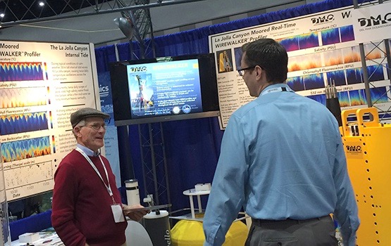 Scripps oceanographer Rob Pinkel (left) describes the Wirewalker instrument at Oceanology International. (Photo Courtesy of Scripps Institution of Oceanography)