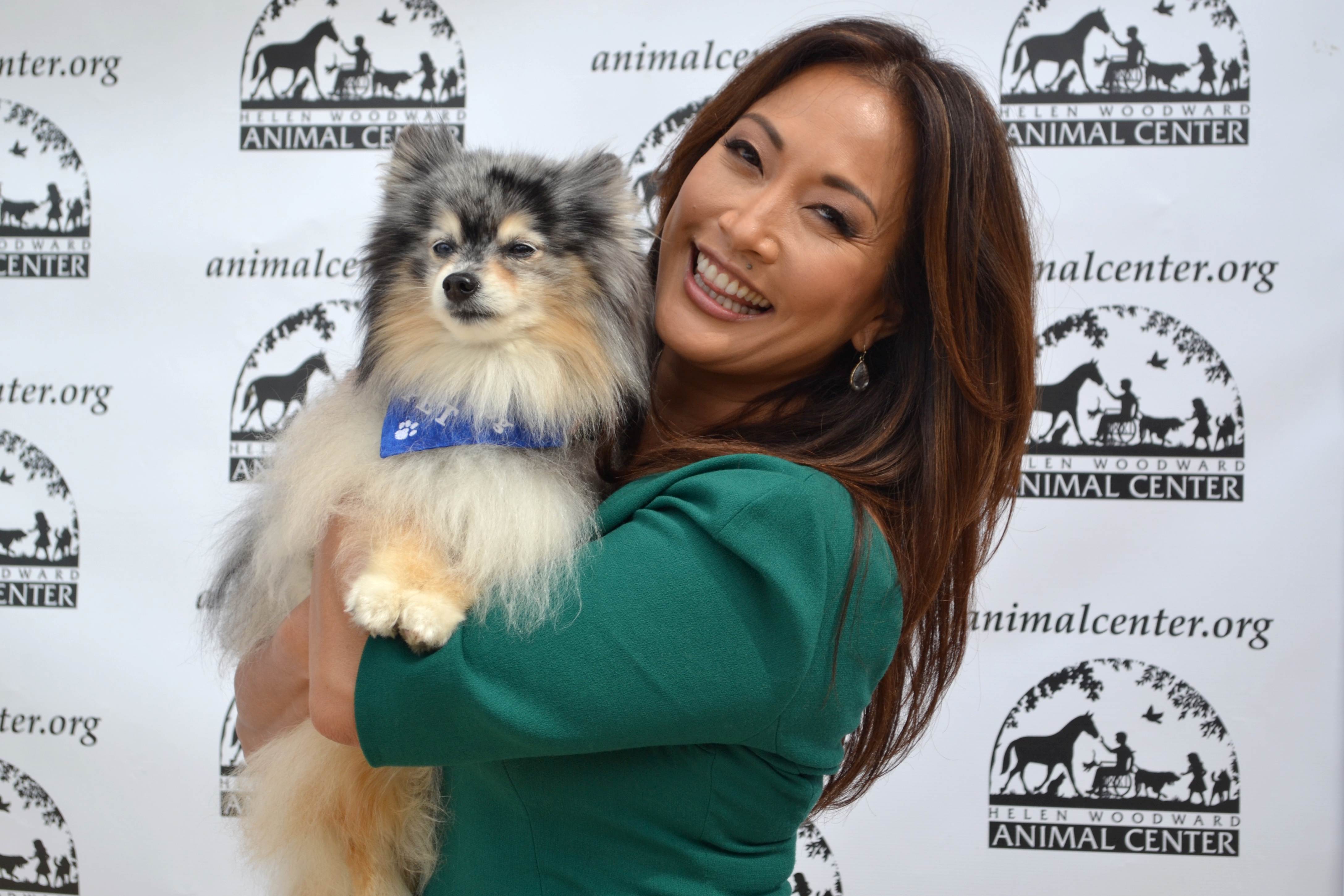 Carrie Ann Inaba cuddles with Center Pet Encounter Therapy pup Balonee.