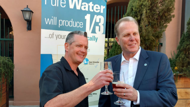 Stone Brewery’s Pat Tiernan (left) and Mayor Kevin Faulconer toast with beer made from 100 percent recycled water. (Photo by Chris Jennewein/Times of San Diego)