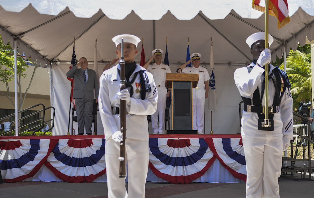 The official party salutes as Naval Medical Center San Diego Color Guard parades the Colors during the centennial ceremony. The Navy's first permanent medical facility was established in Balboa Park on May 20, 1917. (Photo by Culinary Specialist Petty Officer 2nd Class Luther C. Smith Jr.)