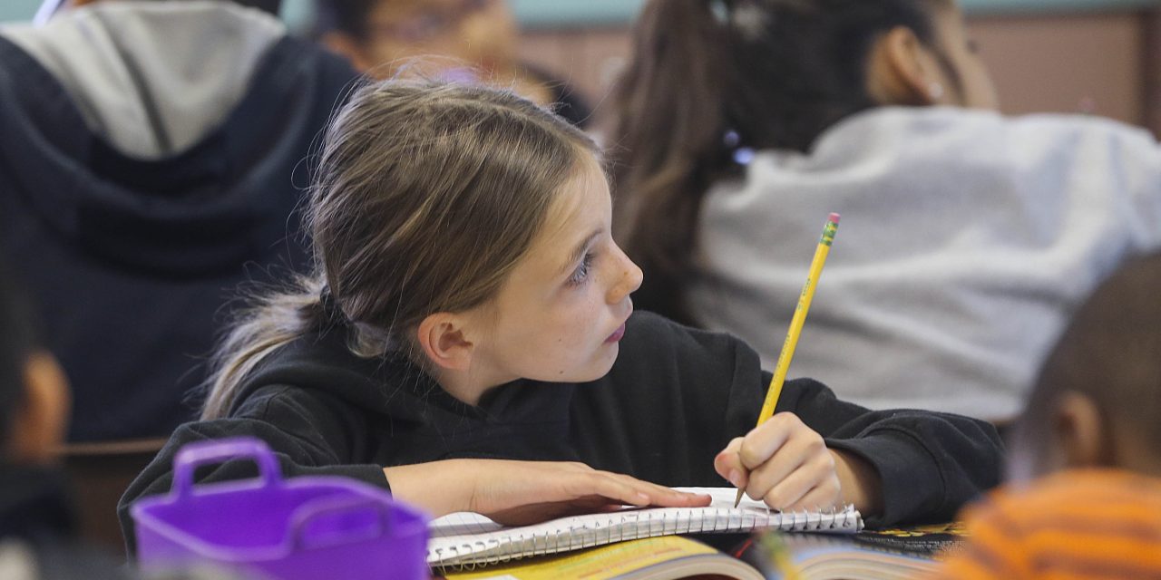 A Greenfield Union student takes notes during class at Kendrick Elementary School in Bakersfield. The district is one of 15 CALmatters studied to understand how well the state’s new school funding formula is working. (Henry Barrios/The Californian)
