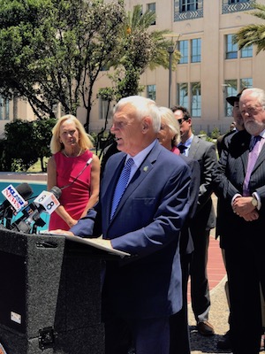 County Supervisor Ron Roberts addresses the media. Supervisor Dianne Jacob is in back, partially hidden by Roberts.