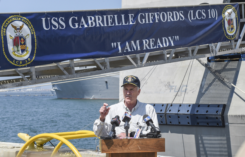 Secretary of the Navy Richard V. Spencer delivers remarks on the pier alongside the littoral combat ship USS Gabrielle Giffords. (U.S. Navy photo by Mass Communication Specialist Seaman Jasen Morenogarcia)