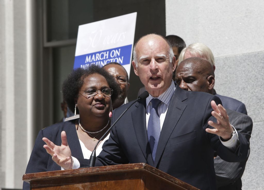 Gov. Jerry Brown joined Assemblywoman Shirley Weber and activists at a ceremony commemorating the 50th anniversary of the March on Washington. (AP Photo by Rich Pedroncelli)