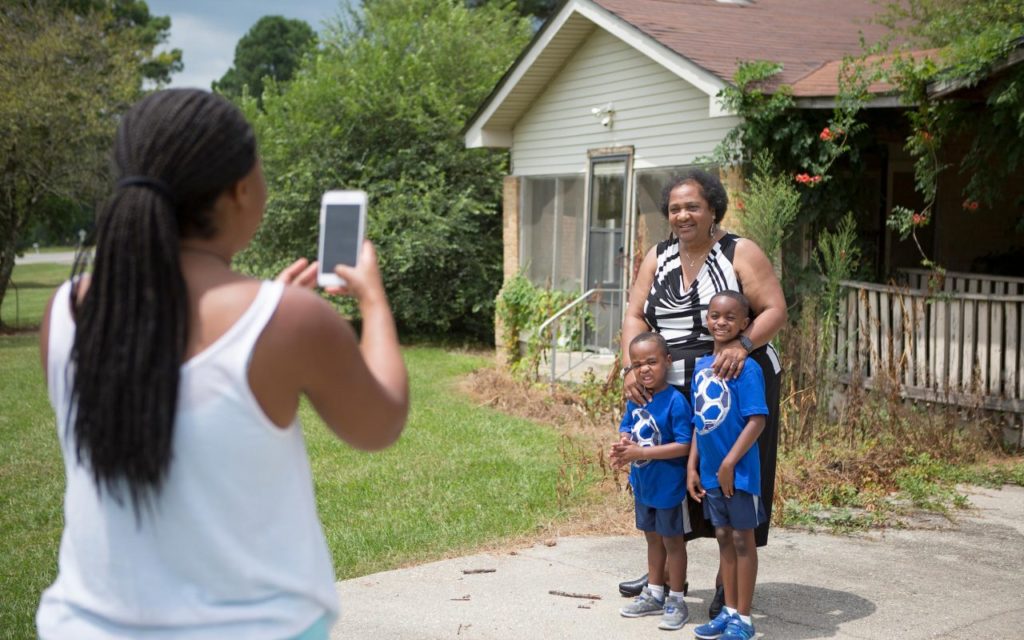 California Assemblywoman Shirley Weber is photographed with her grandchildren by her daughter during a visit to the family homestead in Hope, Arkansas. The home where she was born has been torn down, but the land and the wood frame homes that occupy the acreage are still in the Nash family. (Photo by Evan Lewis for CALmatters)