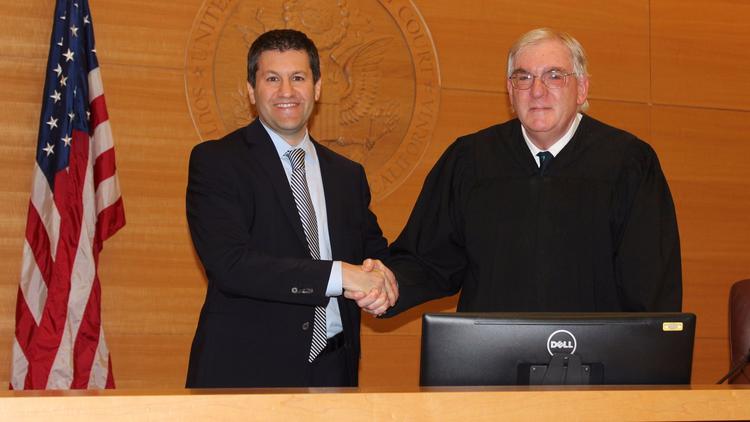 Adam Braverman is sworn in by U.S. District Judge Barry Moskowitz as interim U.S. attorney for San Diego and Imperial counties. (Courtesy of U.S. Attorney's Office)