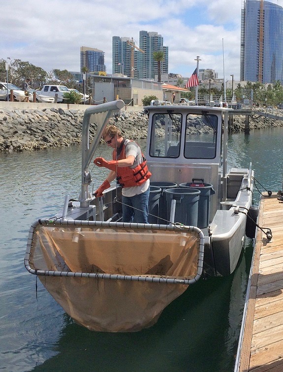 Eric Dieters with Zephyr aboard the company’s custom-made debris removing vessel. (Photo courtesy of the Port of San Diego)