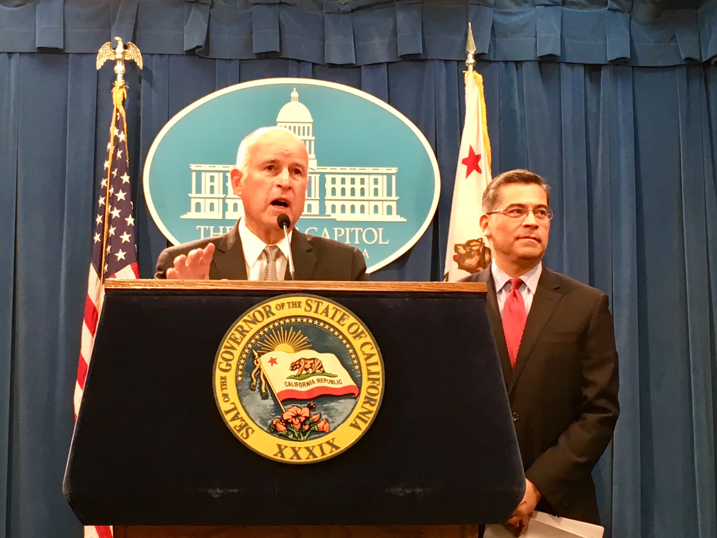 Gov. Jerry Brown and California Attorney General Xavier Becerra address reporters about the federal lawsuit against the state. (Photo by Laurel Rosenhall for CALmatters)