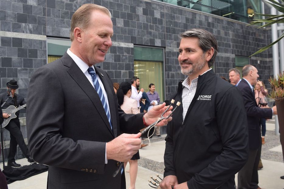Mayor Kevin Faulconer receives Forge-branded pitchfork from Forge Therapeutics CEO Zak Zimmerman. (Photo courtesy of World Trade Center San Diego, affiliate of San Diego Regional EDC)