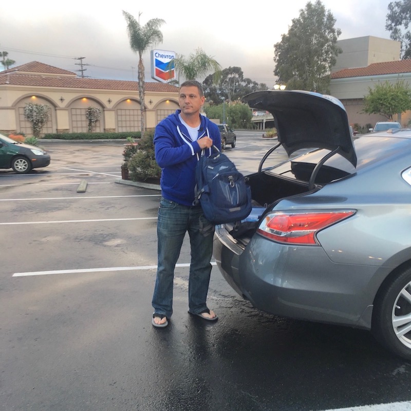 After finishing his first driving shift, Chad Bordes heads to the gym to shower and change before starting his next job selling cars online. (Photo by Amita Sharma, KPBS)