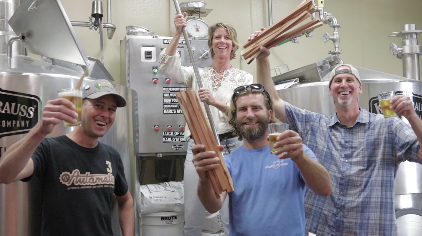 Karl Strauss workers hoist beer and wood to signify the Urban Arbor IPA, brewed with juniper trees. (Credit: Karl Strauss Brewing Company)