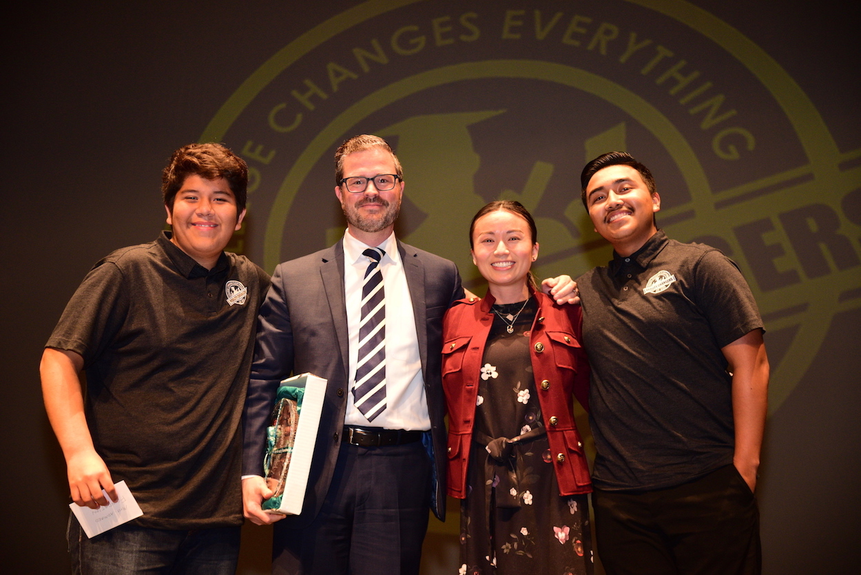 San Diego Foundation representatives Brian Zumbano, vice president of stewardship, and Candace Wo, mitigation and nonprofit manager, are flanked by two students from Reality Changers.