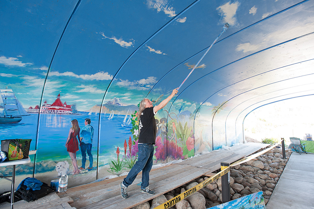 Artist Kevin Anderson works on the ceiling of the 72-foot-long mural he is painting in the pedestrian tunnel under Via Alta in Mission Valley’s Civita Park.