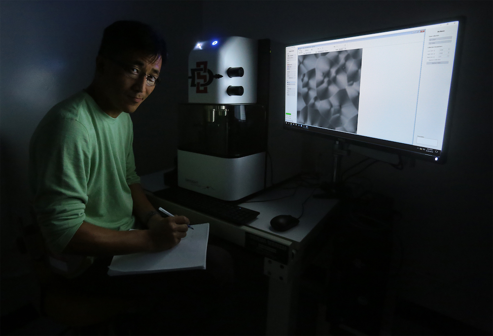 Young Jong Lee, a researcher with the National Institutes of Standards and Technology, uses SDSU's new chemical imaging microscope. (Photo credit: San Diego State University)