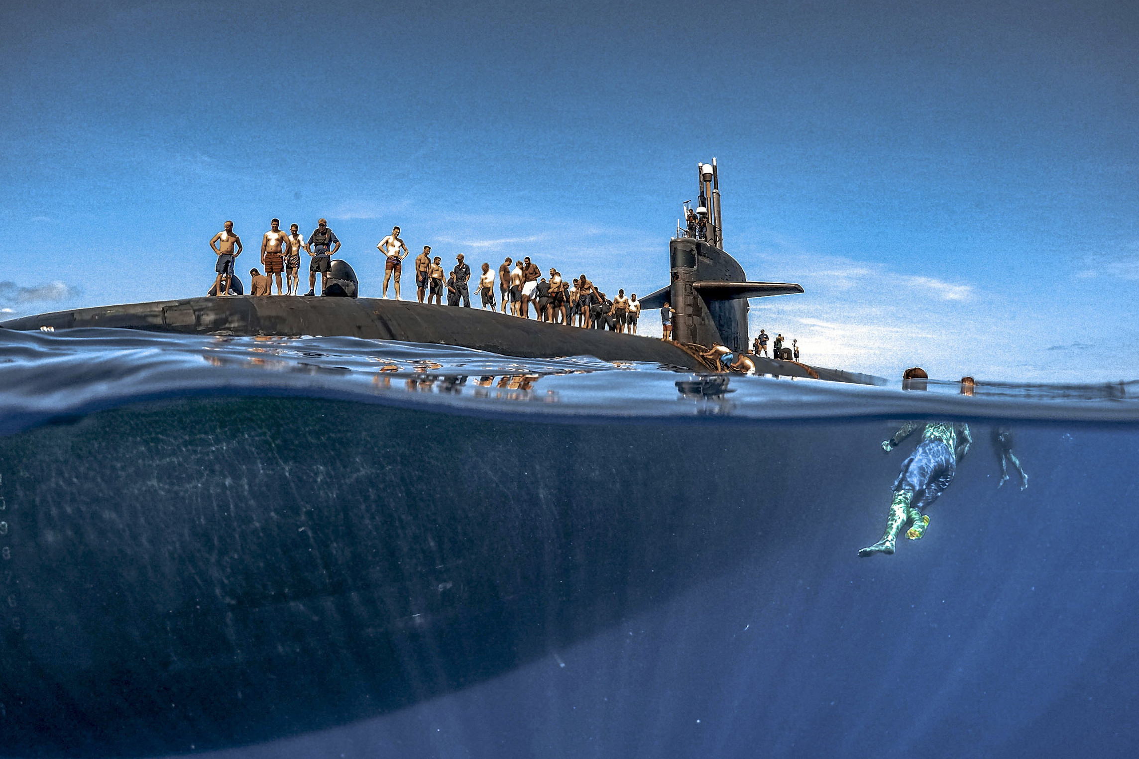 Sailors assigned to Los Angeles-class fast-attack submarine USS Olympia participate in a swim call at sea in the Pacific Ocean, July 31, 2018. (Navy photo by Senior Chief Petty Officer Vien Nguyen)