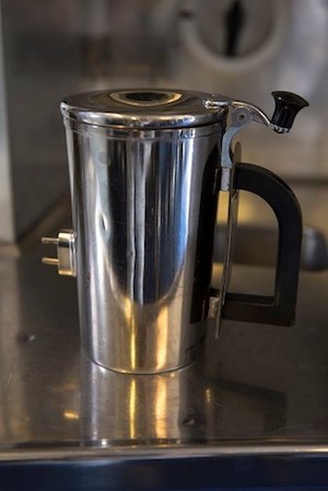 A hot cup sits on a counter inside a KC-10 Extender at Travis Air Force Base, Calif., June 21. The base is working on developing a new handle for the cup which could save the Air Force thousands of dollars. (Photo: Tech. Sgt. James Hodgman/Air Force)