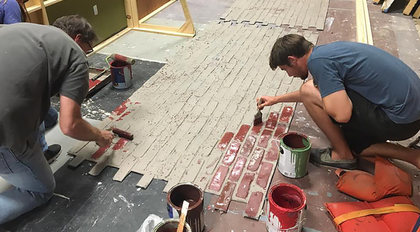 A team works on the construction of an interrogation room to be used for a production. (Credit: SDSU School of Theatre, Television and Film) 