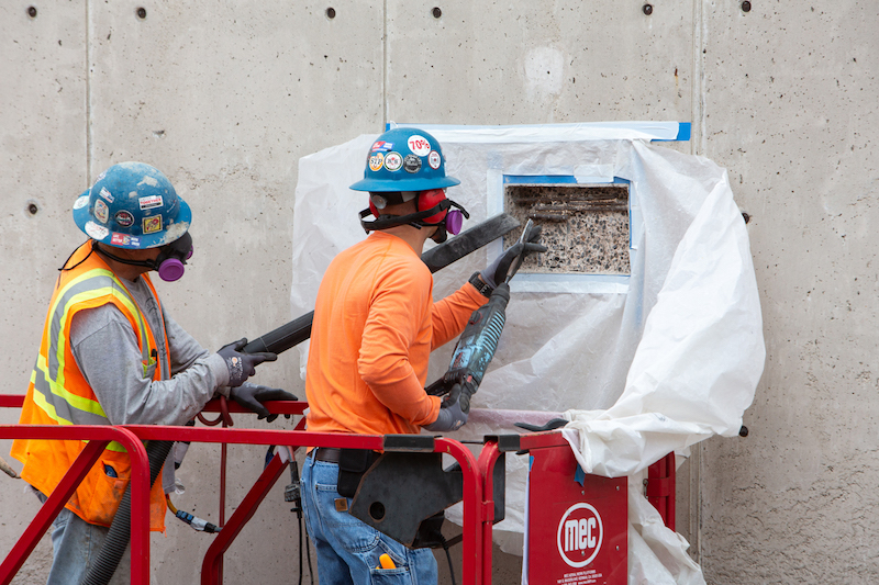 Workers restoring the concrete on the Salk Institute’s iconic walls. (Credit: Salk Institute)
