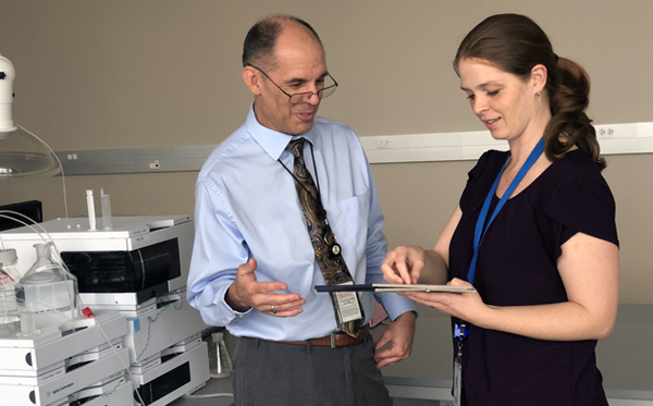 Forensic pathology doctors Steven Campman and Leslie Anderson consult on a case at the San Diego County Medical Examiner’s Office. (Photo courtesy of San Diego County)