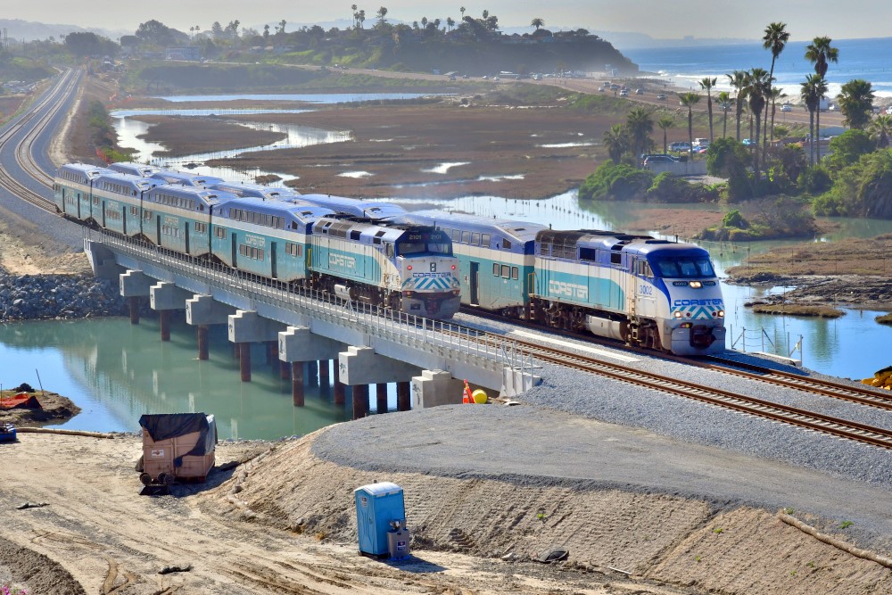 Trains passing during a morning commute on the San Elijo Lagoon double tracked LOSSAN rail line.