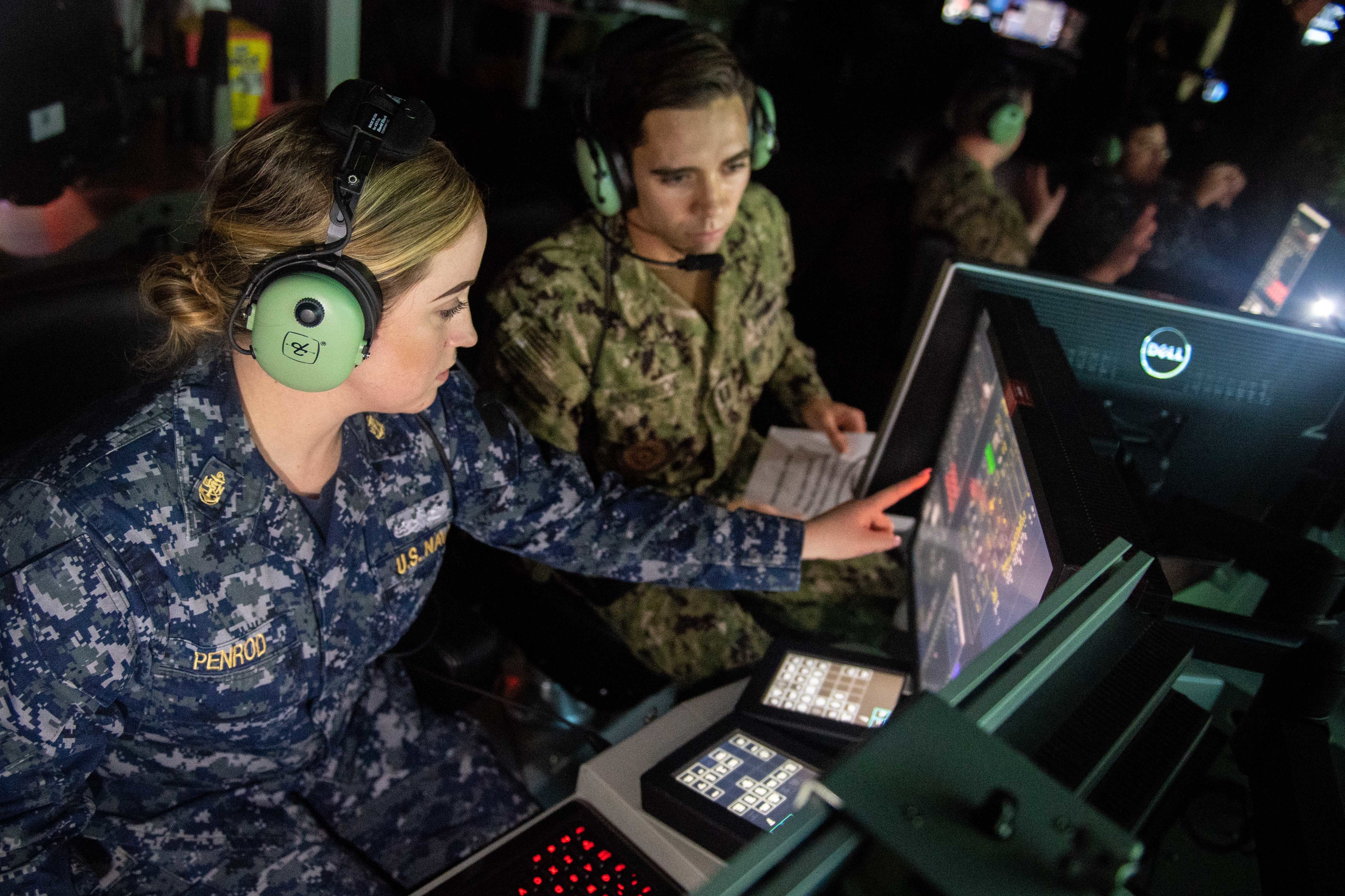 SAN DIEGO — Chief Operations Specialist Anna Penrod, left, assigned to the guided-missile destroyer USS Rafael Peralta, and Lt. Aaron Van Driessche participate in an air defense scenario at the Combined Integrated Air and Missile Defense and Anti-Submarine Warfare Trainer. CIAT is the Navy’s newest combat systems trainer. Rafael Peralta became the first warship to pilot the advance warfare training curriculum at CIAT. (U.S. Navy photo by Mass Communication Specialist 2nd Class Nicholas Burgains)