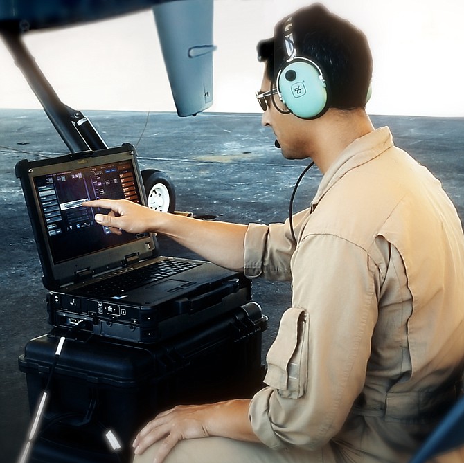 General Atomics technician uses a laptop in conjunction with SATCOM taxi and Automatic Takeoff and Landing Capability for the MQ-9B remotely piloted aircraft.