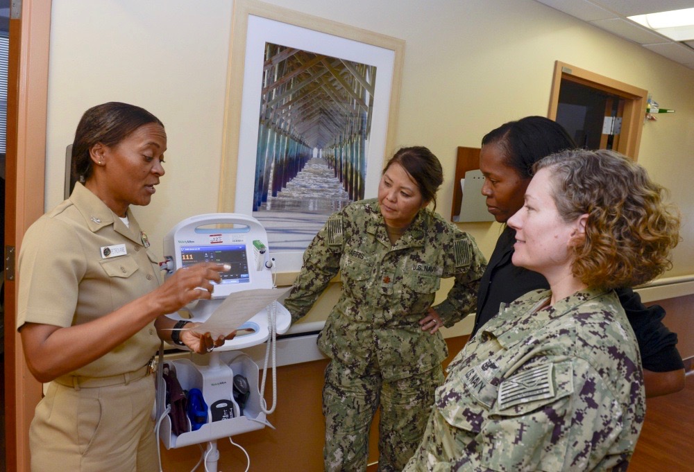 Capt. Andrea Petrovanie goes over the day’s orders with members of her nursing staff at Naval Medical Center San Diego branch clinic. (U.S. Navy photo)