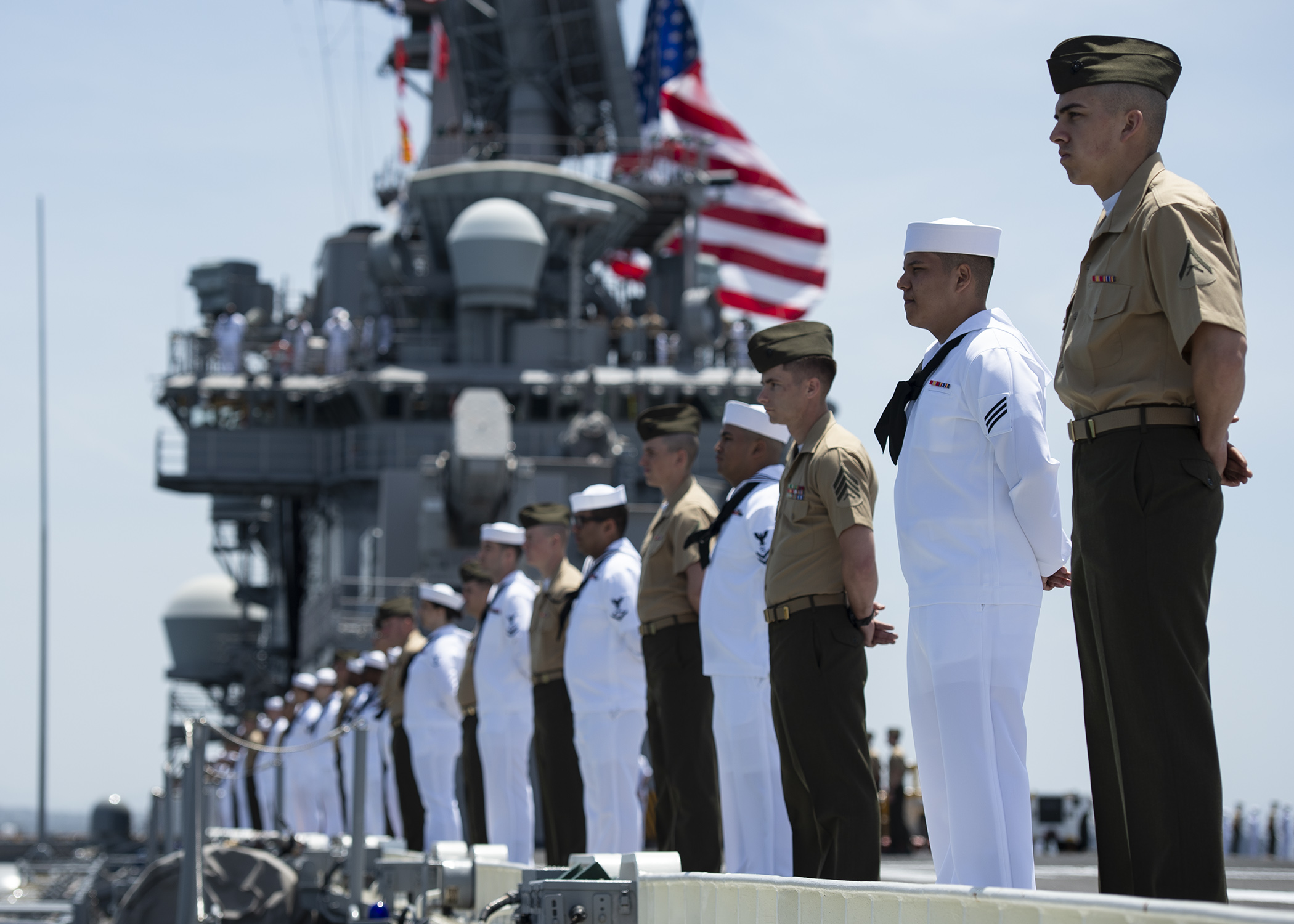 Sailors and Marines man the rails aboard the flight deck of amphibious assault ship USS Boxer as the ship departs its homeport of San Diego. on May 1. Sailors and Marines of the Boxer Amphibious Ready Group and 11th Marine Expeditionary Unit are embarked aboard Boxer for a scheduled deployment. (U.S. Navy photo by Mass Communication Specialist 3rd Class Alexander C. Kubitza)