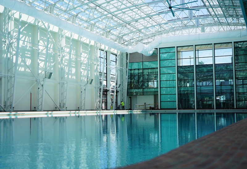 The new facility has the pool on the ground level, with state-of-the-art functional fitness equipment and free weights above on the second floor and roof deck.