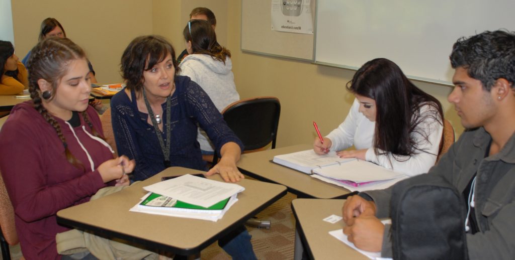 Cuyamaca College Math Instructor Terrie Nichols works with students in a math class. Cuyamaca College’s innovative approach to math allows students to take transfer-level math classes with additional support for those who need it.