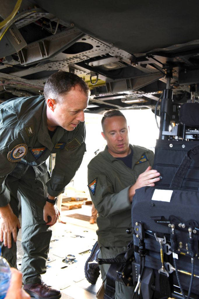 Capt. Ryan T. Carron, commodore of Commander Helicopter Sea Combat Wing Pacific, and Master Chief Aircrewman Darren Hauptmann inspect the redesigned MH-60S Sea Hawk helicopter gunner’s seat at Naval Air Station North Island. (U.S. Navy photo by Mikel Lauren Proul)