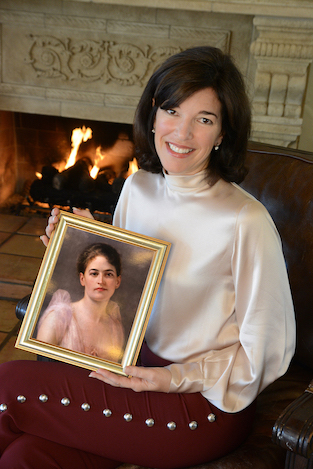 Urban Campout Honorary Chair Nina De Burgh holds a copy of an 1887 painting of her Great-Great Aunt Juliette Gordon Low, who founded Girl Scouts in 1912.