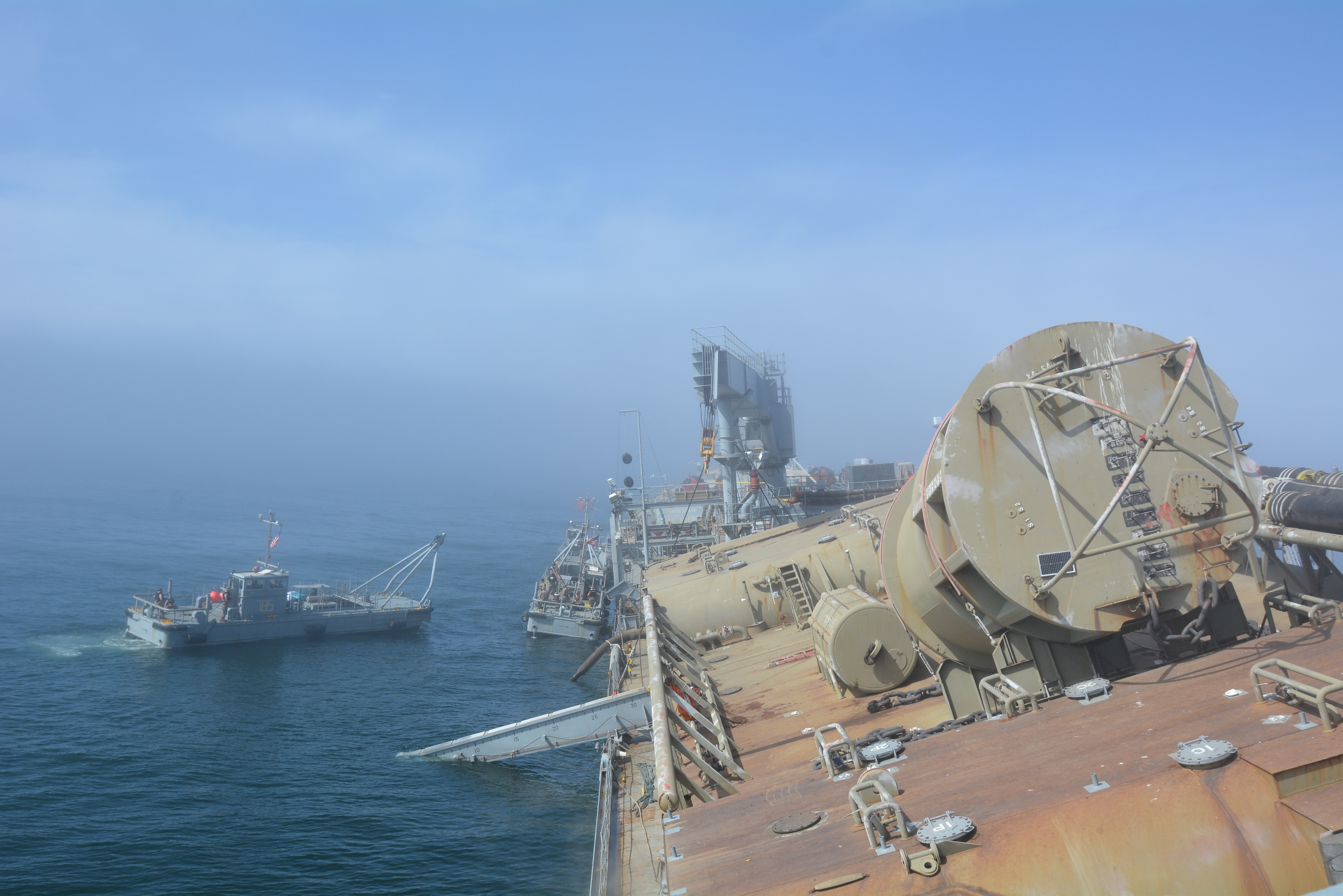 Seabees assigned to Amphibious Construction Battalion 1 approach the Military Sealift Command government-owned tanker ship SS Petersburg during Arctic Expeditionary Capabilities Exercise 2019 off the coast of San Diego. The ship sits in a 12-degree list as it deploys a single-anchor leg mooring buoy, the first of this type of exercise conducted in Southern California. (U.S. Navy photo by Sarah Burford)