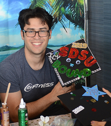 Grossmont College graduate with a San Diego State University mortarboard.